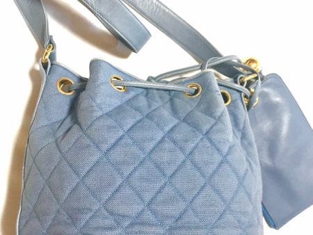 CHANEL Vintage blue quilted canvas and leather combo hobo bucket shoulder bag with drawstrings and golden CC mark balls Supply